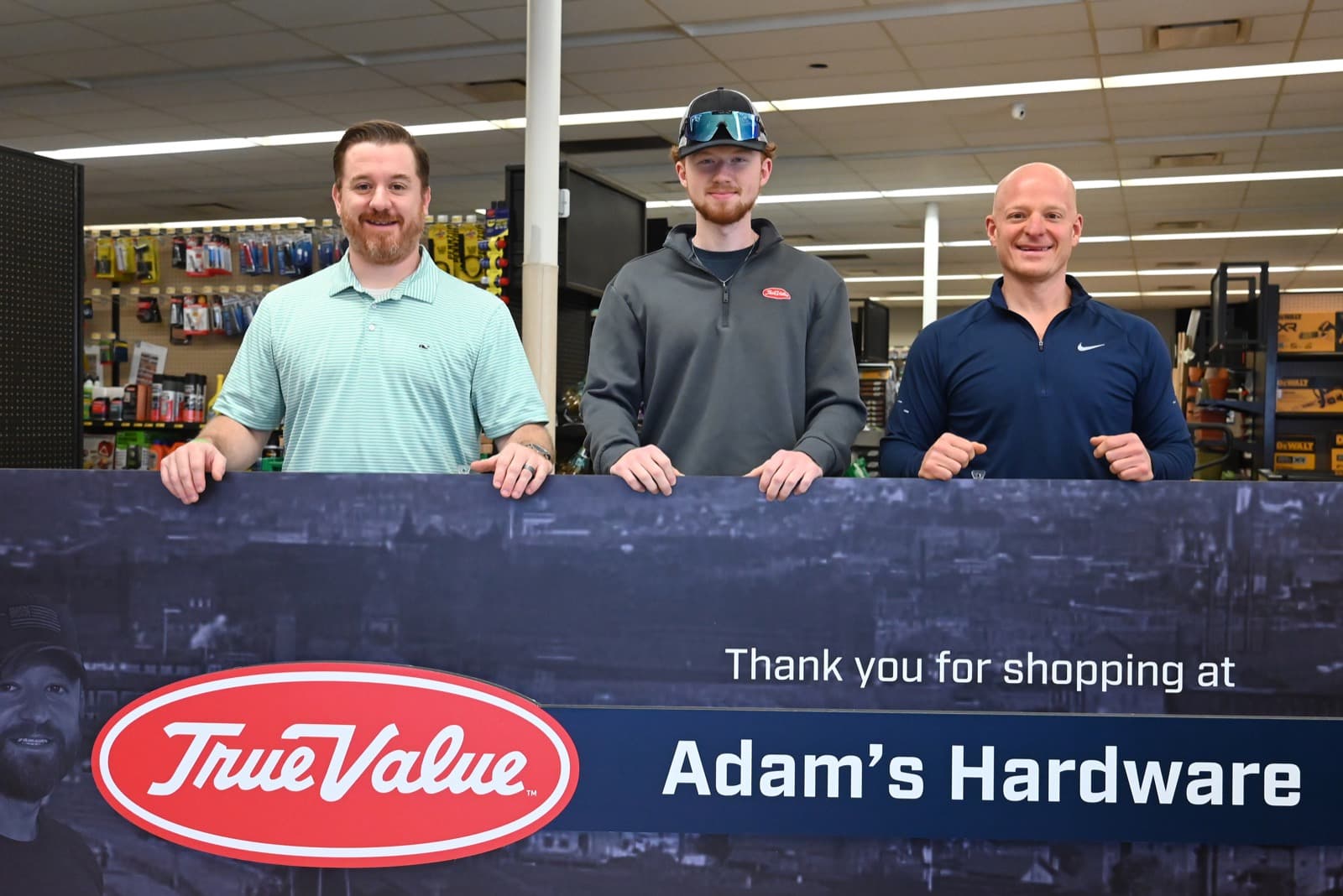 The Tafferas inside the new store, with the Adam's Hardware banner